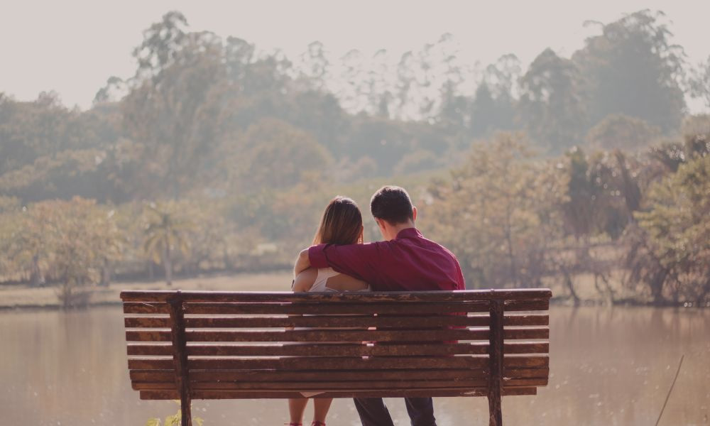 Husband and wife sitting on a bench after a day in their business.