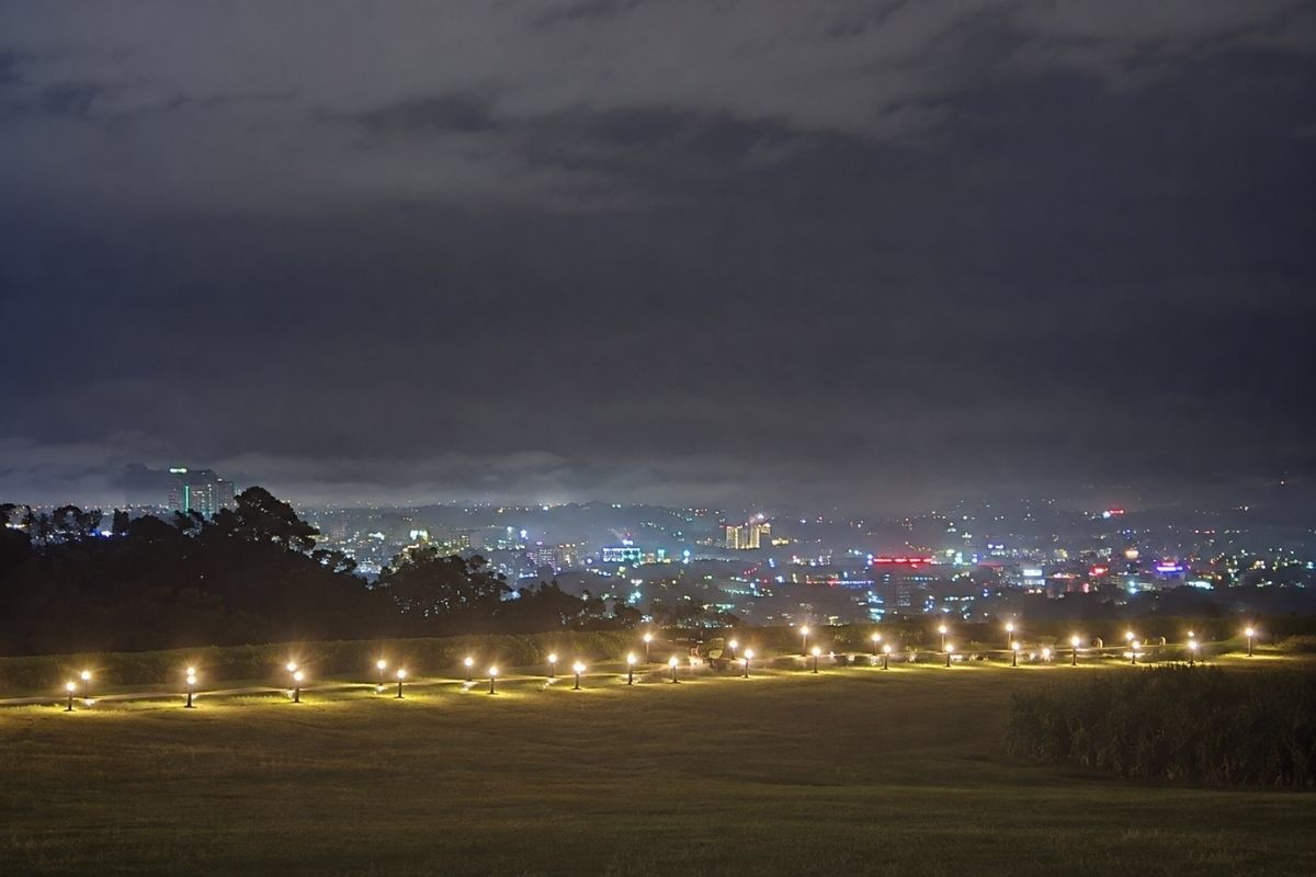 Davao City at night as seen from a hill, showing the bright lights and increasing number of tall buildings.